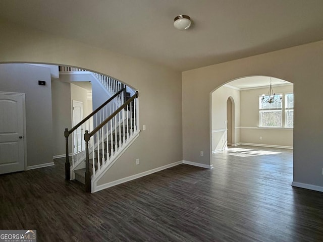 interior space with a chandelier and dark hardwood / wood-style flooring