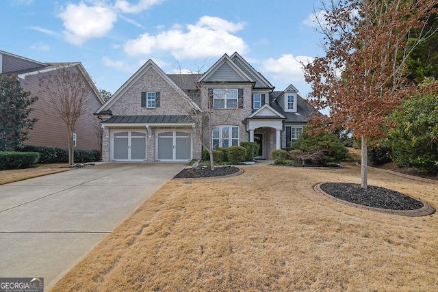 view of front of property featuring a front yard and a garage