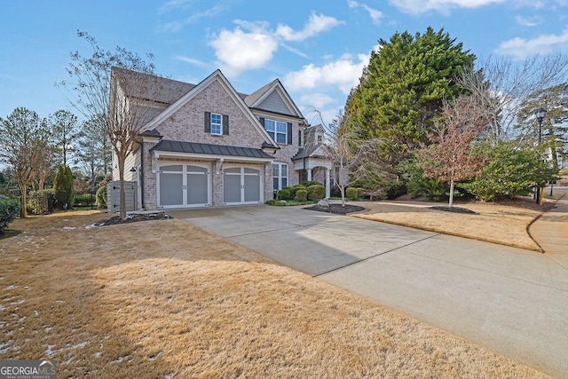 view of front of home featuring a garage and a front lawn