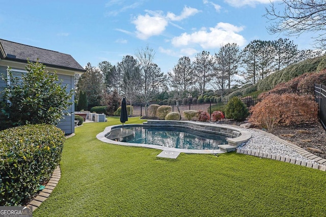 view of pool with a lawn