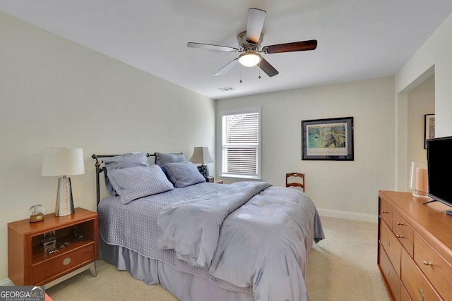 bedroom featuring ceiling fan and light carpet