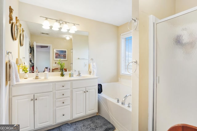 bathroom featuring vanity and independent shower and bath