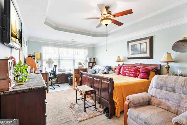 bedroom featuring ceiling fan, ornamental molding, a tray ceiling, and light colored carpet