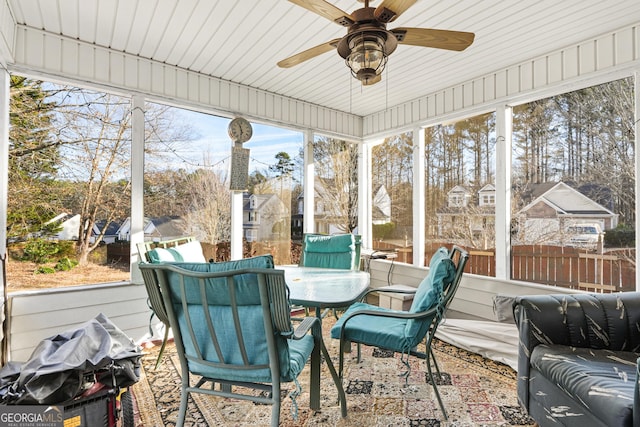 sunroom / solarium featuring ceiling fan and a wealth of natural light