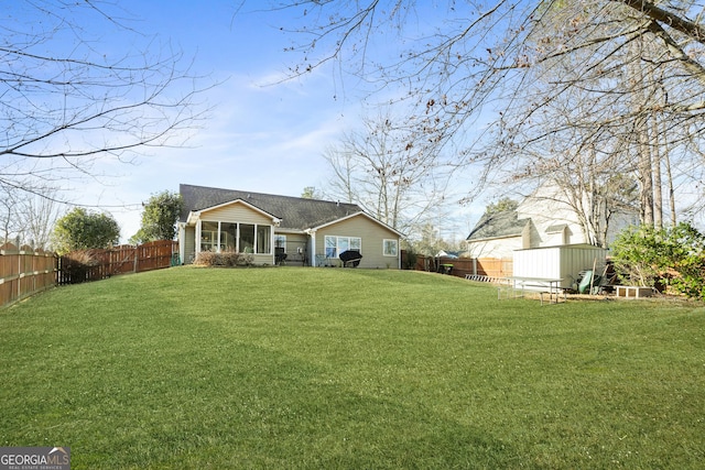 rear view of house featuring a yard