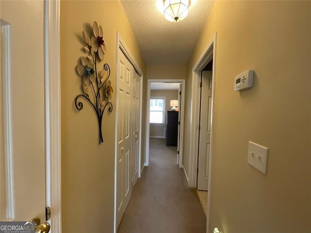 hallway with a textured ceiling