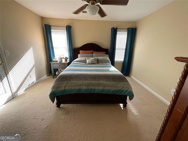 carpeted bedroom with multiple windows and ceiling fan