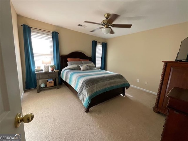 bedroom featuring light carpet and ceiling fan