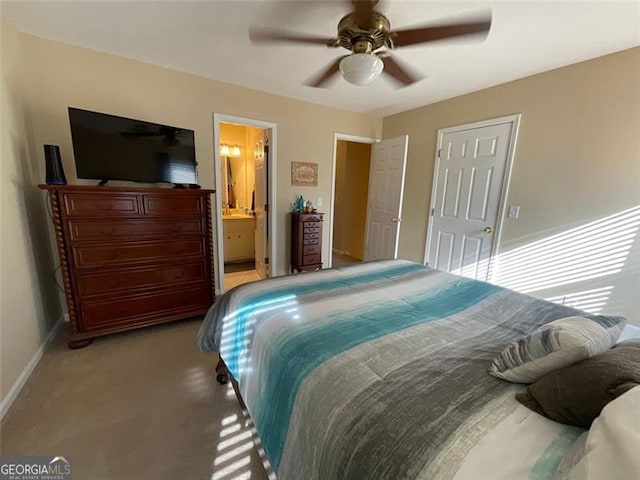 bedroom featuring ensuite bathroom, ceiling fan, and light carpet