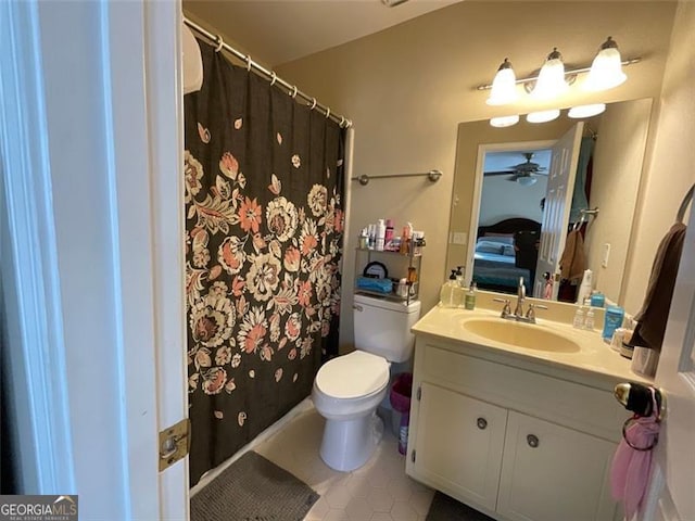 bathroom featuring tile patterned flooring, vanity, toilet, and ceiling fan