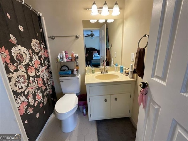 bathroom featuring tile patterned floors, ceiling fan, vanity, and toilet