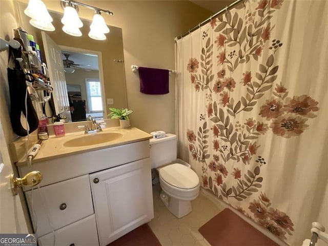 bathroom with vanity, tile patterned floors, a shower with curtain, ceiling fan, and toilet