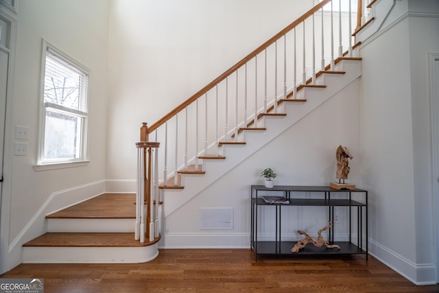 stairway with hardwood / wood-style floors