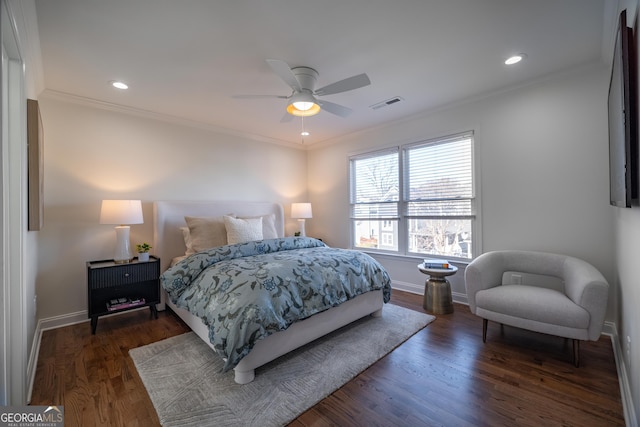 bedroom featuring dark hardwood / wood-style flooring, crown molding, and ceiling fan