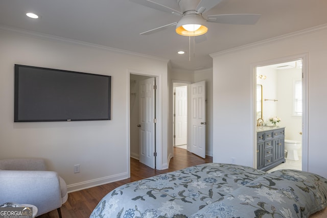 bedroom with crown molding, ceiling fan, connected bathroom, and dark hardwood / wood-style flooring