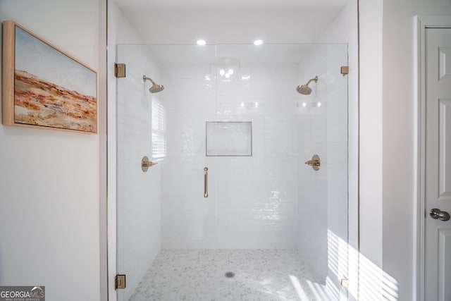 bathroom featuring a shower with door