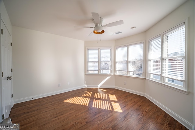 empty room featuring dark hardwood / wood-style floors and ceiling fan