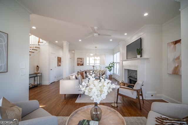 living room with hardwood / wood-style flooring, a high end fireplace, and crown molding