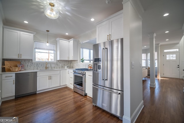 kitchen featuring white cabinetry, premium appliances, and sink