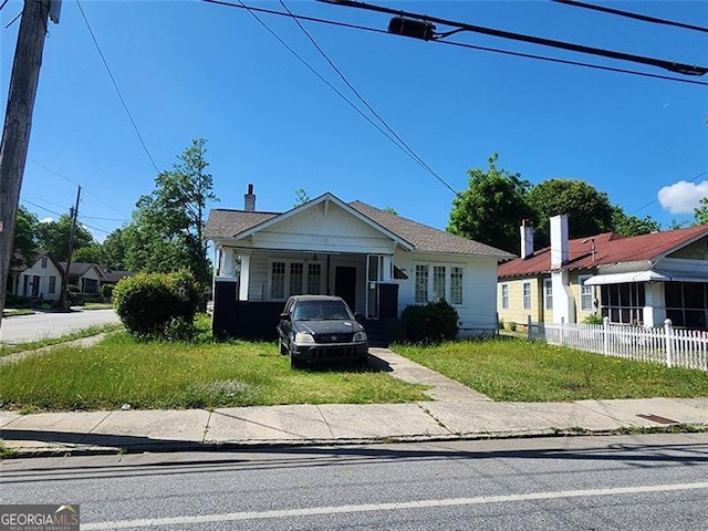 bungalow-style home with a front lawn