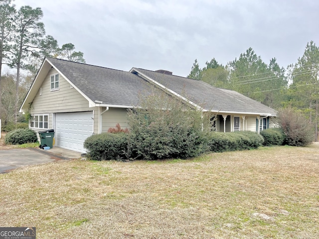 view of front of home with a front yard and a garage