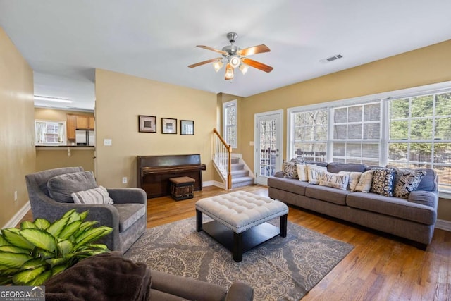 living room featuring ceiling fan and wood-type flooring