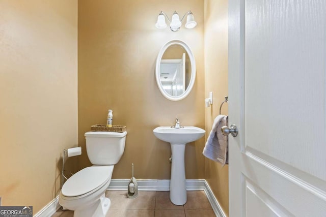 bathroom with tile patterned flooring and toilet