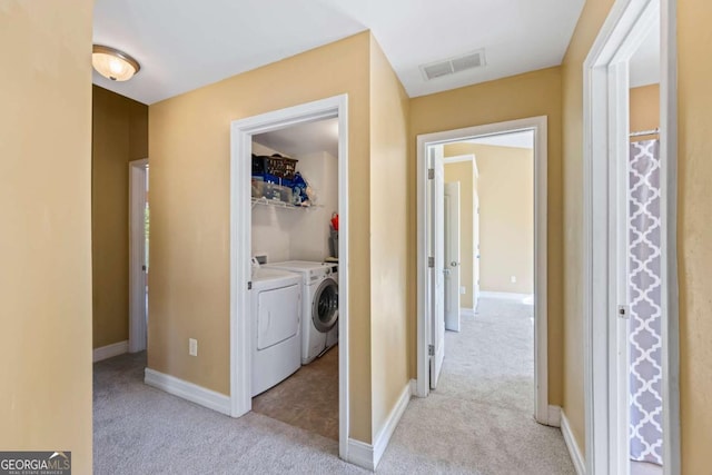 washroom featuring light colored carpet and washing machine and dryer