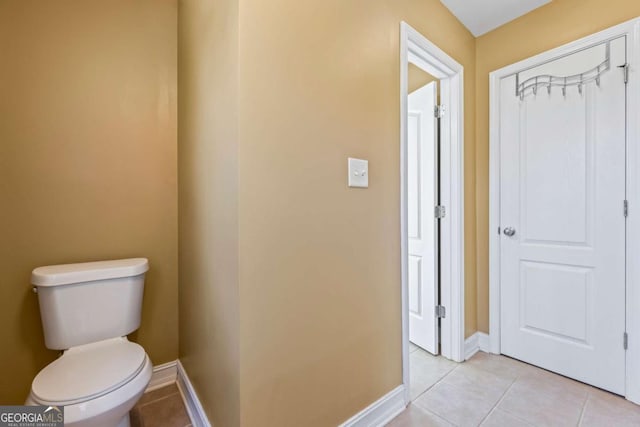 bathroom with tile patterned flooring and toilet