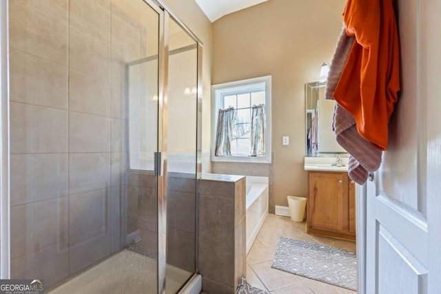 bathroom with shower with separate bathtub, vanity, and tile patterned floors