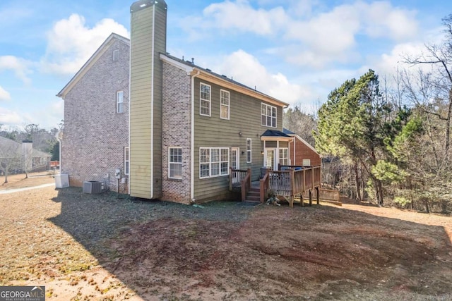 back of property featuring a deck and cooling unit