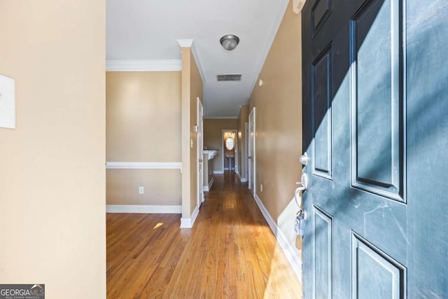 hallway featuring crown molding and hardwood / wood-style floors