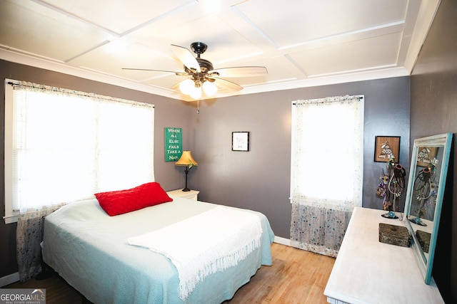 bedroom with ceiling fan, light hardwood / wood-style flooring, and coffered ceiling