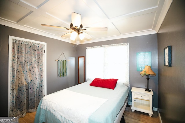 bedroom with coffered ceiling, hardwood / wood-style floors, and ceiling fan