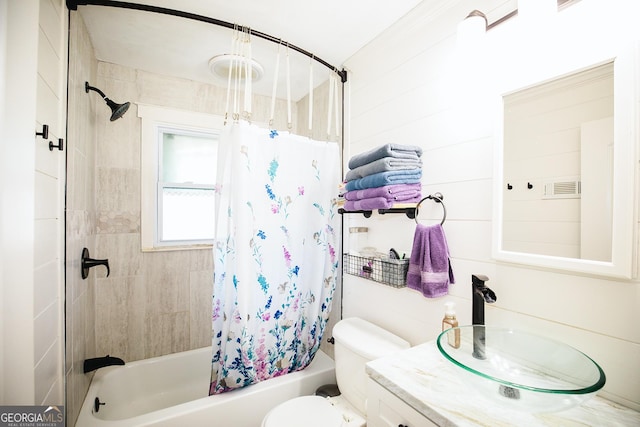 full bathroom with toilet, shower / bath combo with shower curtain, and vanity