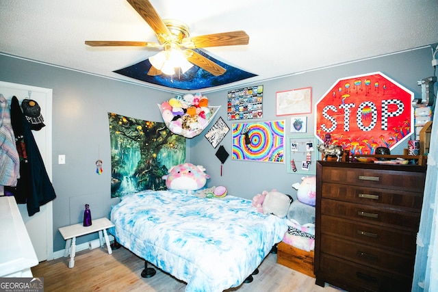 bedroom with ceiling fan and light hardwood / wood-style floors