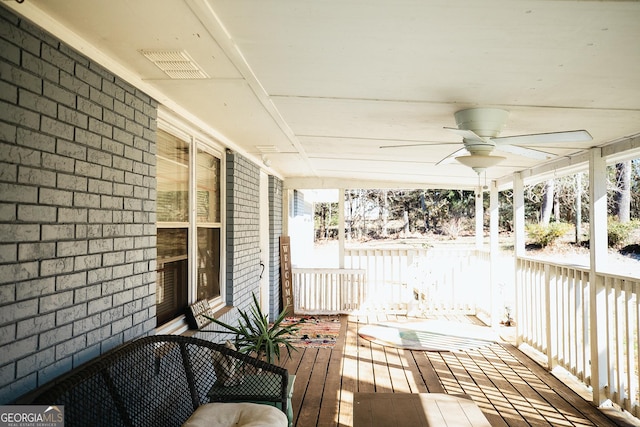 wooden deck featuring a porch and ceiling fan