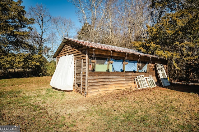 view of outbuilding featuring a lawn