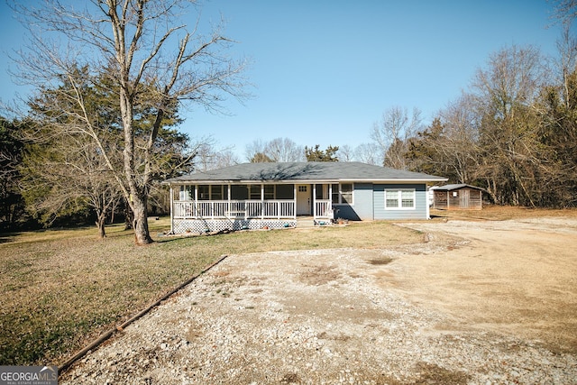 view of front of property with a front yard and covered porch