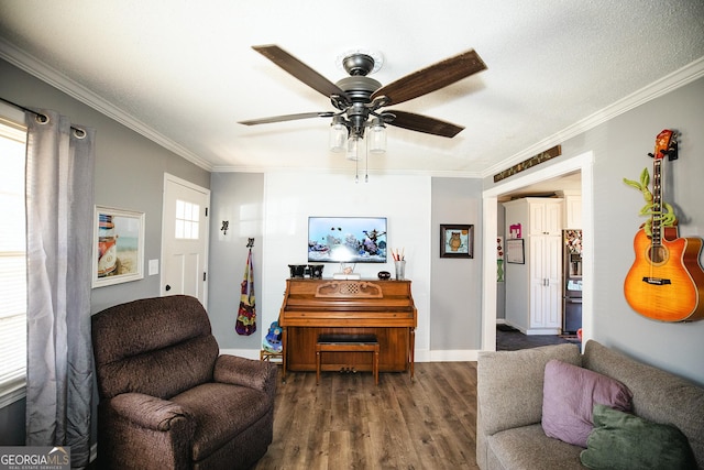 living area with dark hardwood / wood-style flooring, ceiling fan, and crown molding