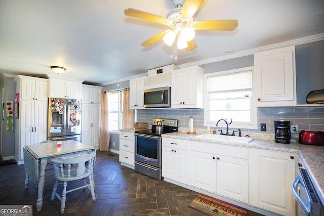 kitchen with stainless steel appliances, dark parquet floors, white cabinets, and sink