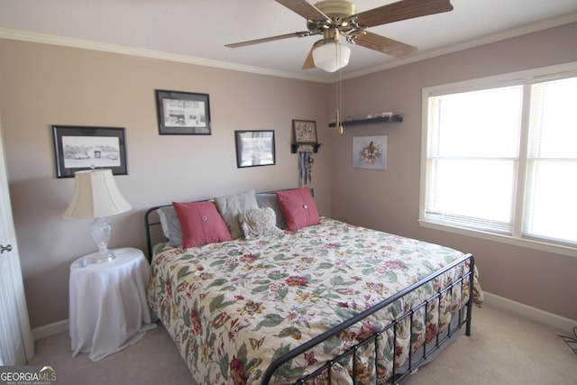 bedroom featuring ceiling fan, crown molding, and light colored carpet