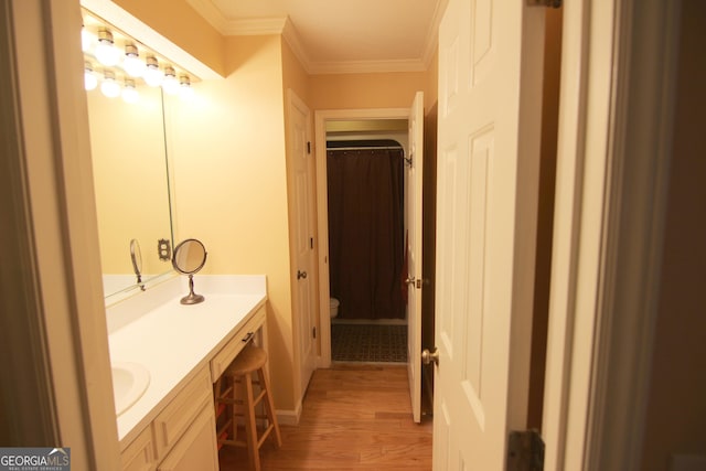 bathroom featuring hardwood / wood-style floors, vanity, toilet, and crown molding