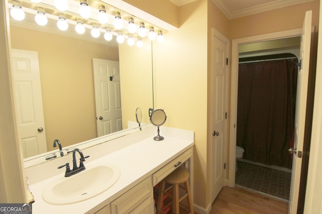 bathroom featuring vanity, hardwood / wood-style flooring, toilet, and crown molding