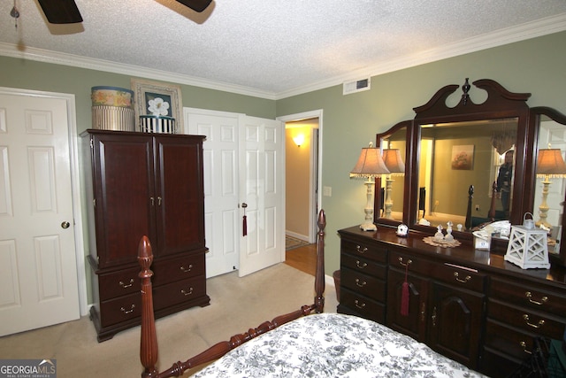 carpeted bedroom featuring a textured ceiling, ceiling fan, and crown molding