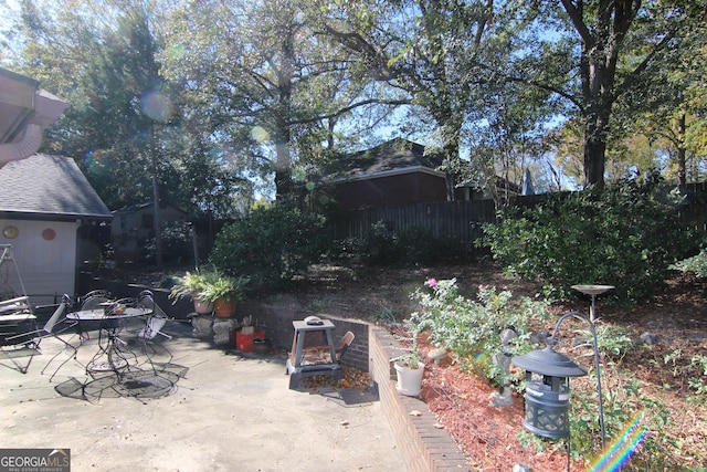 view of yard featuring a patio and an outdoor fire pit