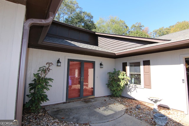 view of exterior entry with french doors and a patio