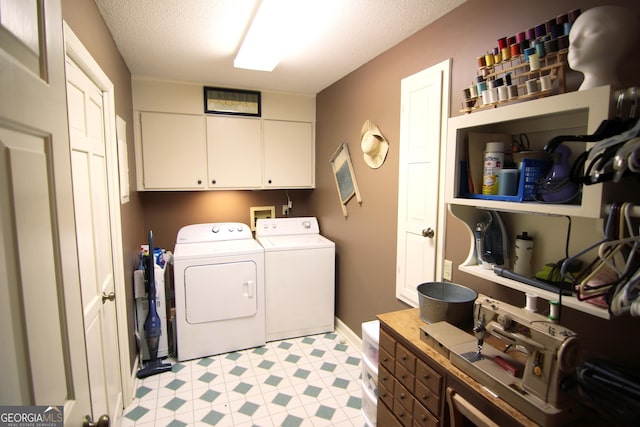 washroom featuring cabinets, independent washer and dryer, and a textured ceiling