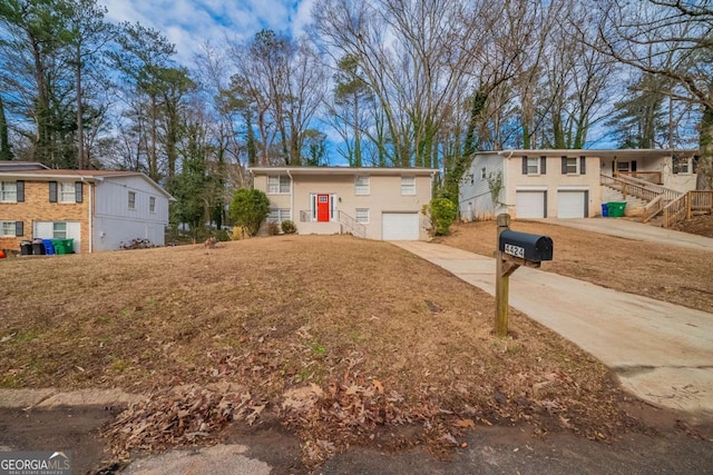 bi-level home with a garage and a front lawn