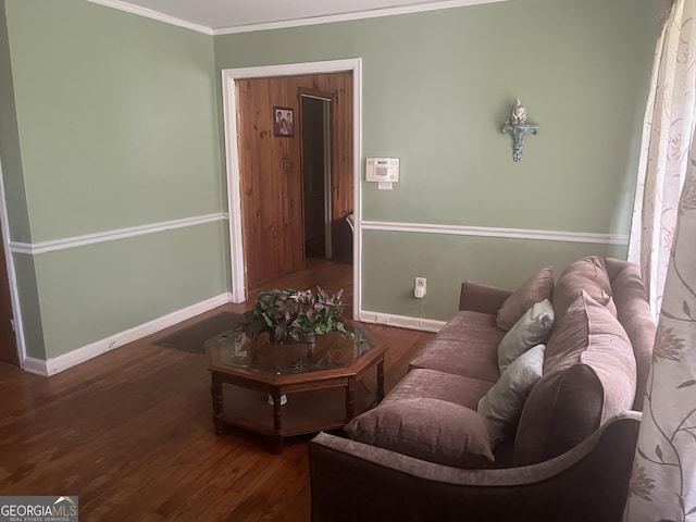 living room featuring dark wood-type flooring and crown molding